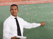 a man stands in front of a blackboard with mathematical equations written on it