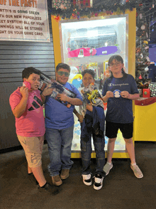 a group of young boys standing in front of a machine that says " of the past "