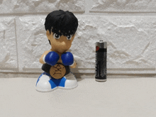 a figurine of a boxer is next to a super aa battery