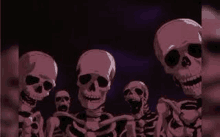 a group of skeletons are standing next to each other and smiling .