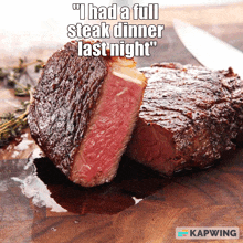 a steak on a wooden cutting board with a caption that says " i had a full steak dinner last night "