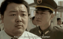 a man in a military uniform says " you 're a disgrace to your mother " in front of another man