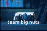 a group of monsters from monsters inc standing in front of a screen that says " team big nuts "