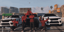 a bunch of people in red hoodies are posing in front of a range rover