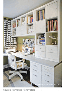 a picture of a desk with a laptop on it and a bookshelf behind it