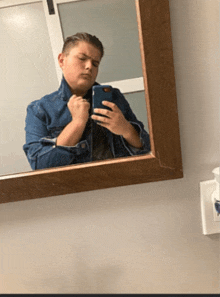 a person taking a selfie in a mirror with a phone