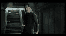 a man is walking up a set of stairs in a dark room .