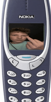 a nokia cellphone with a picture of a boy on the screen