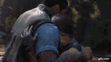 a man and a woman are hugging each other in a video game scene .