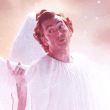 a man in a white angel costume is making a face