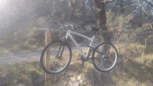 a bicycle is leaning against a wooden post with a sign that says " no parking "