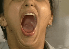 a close up of a woman with her mouth wide open