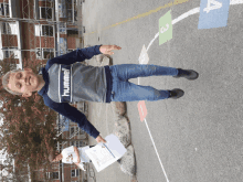 a boy wearing a shirt that says hummel stands on a playground