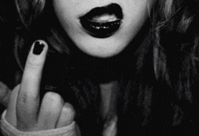 a black and white photo of a woman with black lipstick