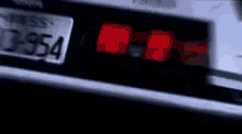 a close up of a car 's tail light with a license plate that says 32554