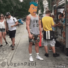 a man wearing a tank top that says hw on it is standing in front of a food truck