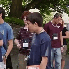 a group of young men are standing in a line with one wearing a name tag that says ' a ' on it