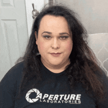 a woman wearing a black shirt that says aperture laboratories on it