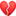 a blurred image of a broken red heart on a white background