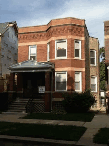 a brick house with a sign on the front of it that says ' a ' on it