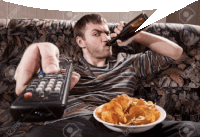 a man sitting on a couch holding a remote control and a bowl of chips