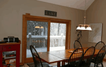 a dining room with a sign that says lake on the wall