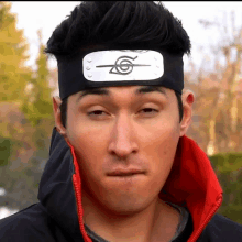 a man wearing a headband that has a symbol on it