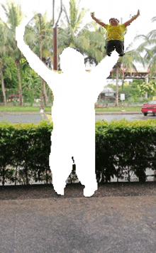 a man in a yellow shirt is jumping in the air with his arms outstretched