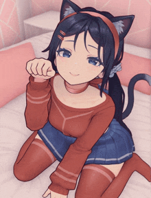 a girl with a cat ear headband is kneeling down on a bed