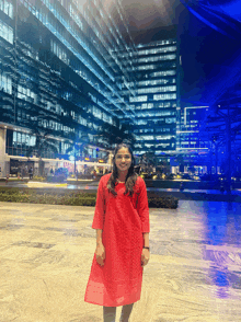 a woman in a red dress is standing in front of a building that says ' apollo ' on it