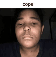 a close up of a person 's face with the word cope written above it .