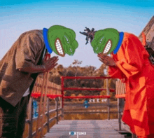 two people with green frog masks on their faces