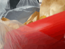 a red item is laying on a plastic bag