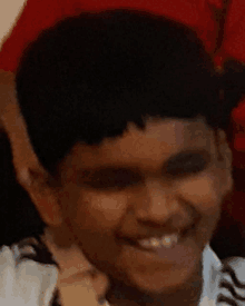 a close up of a child 's face with a smile on his face