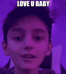 a young boy is making a funny face in front of a purple background with the words `` love u baby '' .