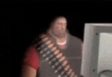 a blurry picture of a man looking at a computer monitor .