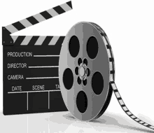 a film reel is sitting next to a clapper board on a white background .