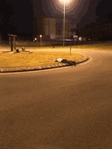 a person is laying on the side of the road in front of a sign that says ' agenzia '