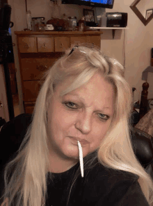 a woman smoking a cigarette with a cigarette sticking out of her mouth