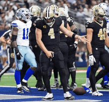 a football player with the number 4 on his jersey is surrounded by other players