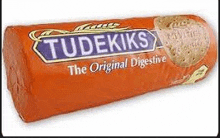 a roll of budekiks the original digestive biscuits on a white surface .