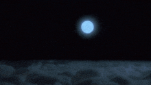 a full moon is shining brightly over a cloudy sky