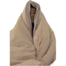 a person wrapped in a blanket with their face visible