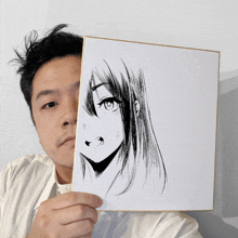 a man holds up a drawing of a girl 's face