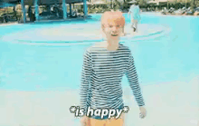 a man in a striped shirt is standing in a pool with the words " is happy " on the bottom