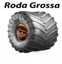 a monster truck tire with a picture of a man in the center .