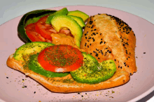 a sandwich with avocado tomatoes and sesame seeds on a plate