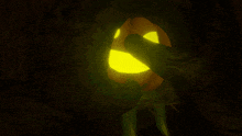 a pumpkin with a face carved into it glows in the dark