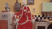 a cartoon character dressed as a piece of meat is dancing in a kitchen with a microwave .