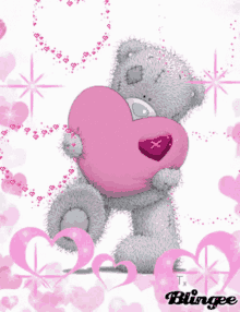 a picture of a teddy bear holding a pink heart with the word blingee at the bottom